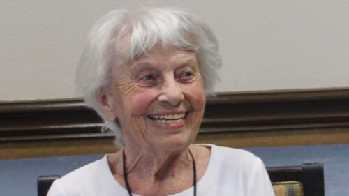 Smiling elderly woman with white hair.