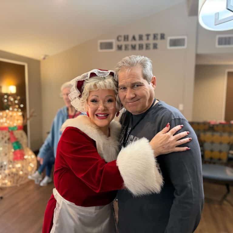 Festive holiday event with costumed characters indoors.